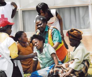 A St John volunteer cares for a patient at a public event